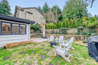 Private backyard with pavers and adirondack chairs included.