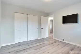 Primary bedroom with generous closet storage and flexible layout.