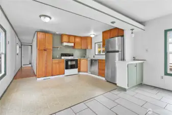 Kitchen with stainless steel refrigerator and dishwasher.