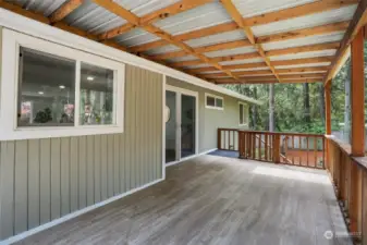 The covered back deck is expansive and overlooks the beautiful back yard.