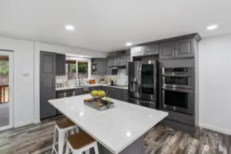 Quartz countertops decorate the kitchen beautiuflly, and the great layout allows for easy meal preparation while enjoying guests.