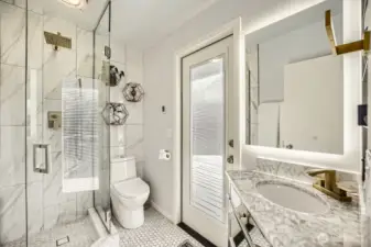 Primary ensuite bath with door to deck and hot-tub just outside