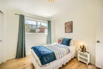 2nd bedroom looks out to  lush backyard