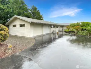 Black topped circle Driveway with two rodiron gates.