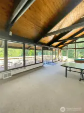 Large inside club house with fire place and table and chairs