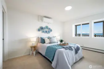 The lower level bedroom is spacious and features ample natural light and water views, plus a walk-in closet.
