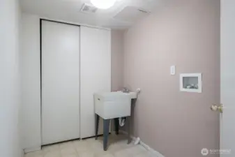 The lower level features a separate laundry room and ample storage space. There is also a built-in vacuum system.