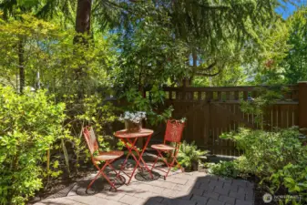 Inviting front corner patio with abundant natural light to enjoy a peaceful cup of tea or space to garden