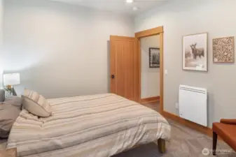 Comfortable guest bedroom with warm finishes and plenty of natural charm.