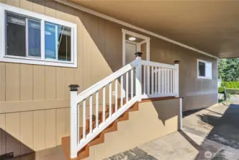 Convenient side entry with stairs beneath the carport.