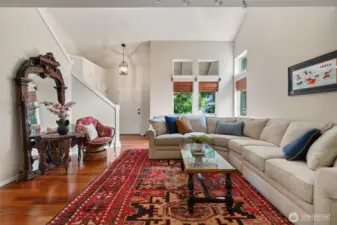 Living room with soaring ceilings looking toward the front entry.  Great natural light in this room.