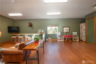 As you enter the gathering/family room area from the kitchen you will notice how perfectly this room is set up for entertaining, with a bar, and a relaxing sitting/conversation area.