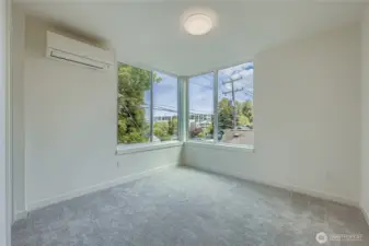 Private primary bedroom with natural light