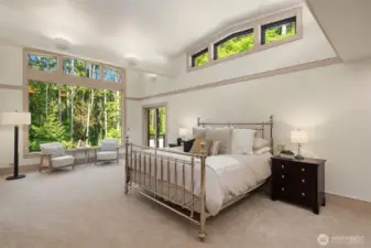 The main-floor primary suite is a true sanctuary, featuring dramatic clerestory windows that frame stunning backyard and park views.