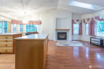 Well lit living room area with lots of windows and a skylight