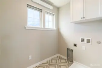 Upper level laundry room with additional storage.