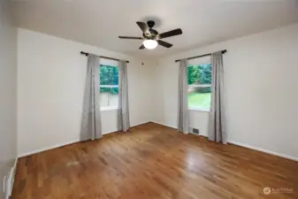 Upstairs bedroom #2 with hardwood floors and ceiling fan.