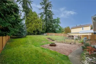 Huge back yard with gardens, patio with firepit, chicken coop, newer shed with workshop space and covered RV or boat parking.