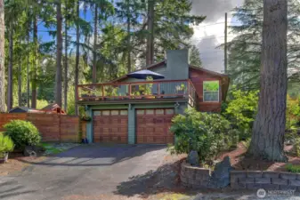 Attached 2-car garage with a deck above (including newer railing)