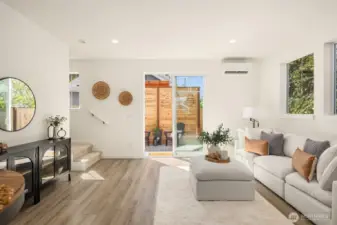 Living room flowing seamlessly to outdoor space through sliding glass doors.