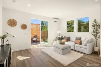 Spacious living room featuring large windows providing natural light.