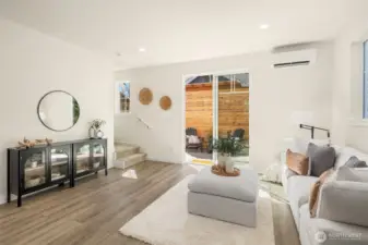 Living room featuring sliding glass doors out to backyard.