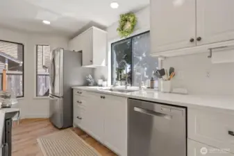 Beautifully remodeled kitchen with undermount sink, quartz countertops, Stainless Steel appliances, new cabinets, new flooring, and LED lighting.