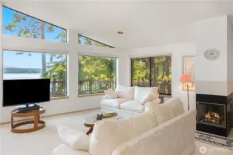 Three-sided fireplace beautifully separates the living room and primary bedroom, providing warmth and ambiance to both spaces.
