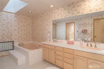 Primary bath offers double sinks, a spacious soaking tub, and a separate walk-in shower—designed for relaxation and convenience.