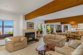 View across the living and dining rooms highlights the open layout, drawing your eye toward the inviting, well-appointed kitchen.