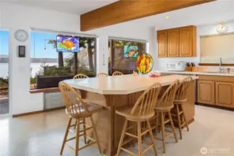 Spacious kitchen features a large island with enough seating for eight—perfect for casual meals, entertaining, and gathering with friends and family.