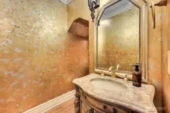 Powder room with gold foil wall finish