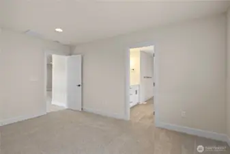 Primary bedroom suite with luxurious master bathroom that has double sinks
