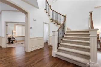 Elegant hardwood flooring and grand staircase set the tone for the home.