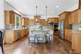 Oversized kitchen island anchors this gourmet chef’s kitchen.