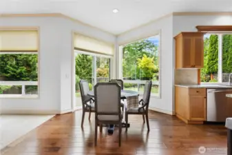 Sunny breakfast nook with views of the backyard and open space beyond.