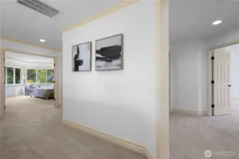 Bright and inviting landing with plush carpeting and graceful architectural details—connecting upper-level bedrooms.