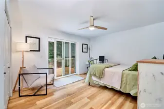 The second bedroom is very spacious and offers hardwood flooring, ample closet space and a sliding door to the back deck.