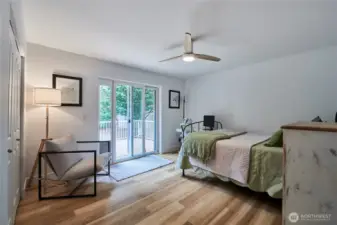 The second bedroom is very spacious and offers hardwood flooring, ample closet space and a sliding door to the back deck.