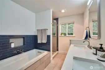 The hall bathroom is shared by the 2nd and 3rd bedrooms and has been fully renovated with double vanities and a generous soaking tub and shower surround with custom tile work.