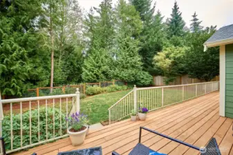 A look at the rear deck overlooking the fenced back and the trees beyond. A very relaxing setting....