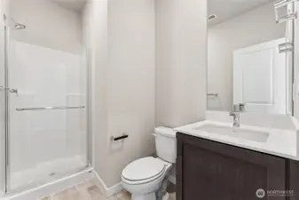 Downstairs bath features a walk-in shower. Pictures are for representational purposes only, colors and features may vary.