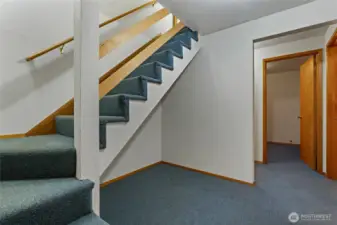 Stairs leading to basement in primary home. 2 additional rooms, 3/4 bath + laundry & access from garage.