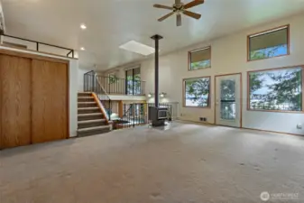 Enter into the spacious living room in the ADU. Stairs lead to bonus flex space.