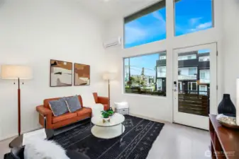 Living room with enormous ceiling height and a glorious amount of natural light.