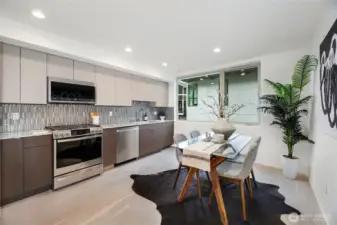 Wide open kitchen and dining. Quartz countertops. Modern sleek design.
