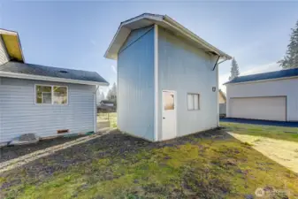 Back of house with room to build an addition. 1 car garage with storage loft