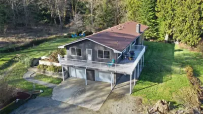 Amazing wrap around exterior deck with sweeping views of this beautiful property , brand new exterior paint and garage doors.