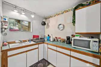 Showing the other half of the kitchen - sink looks out toward the parking.