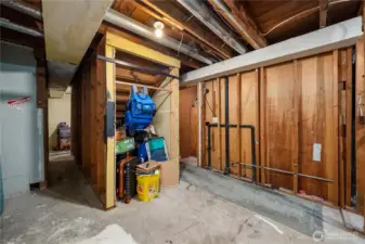 The bathroom is the room on the right. Storage under the stairs is convenient for travel supplies.